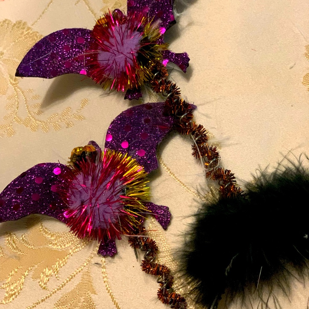 Two black headbands with purple sparkly bats on ends of each antenna.